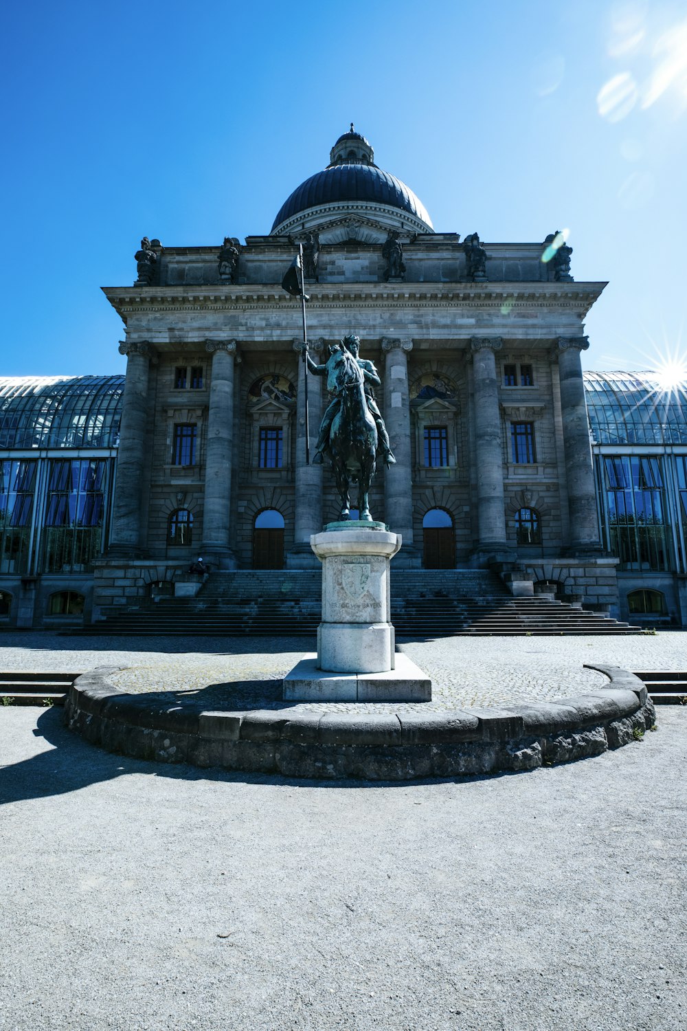 a large building with a statue in front of it