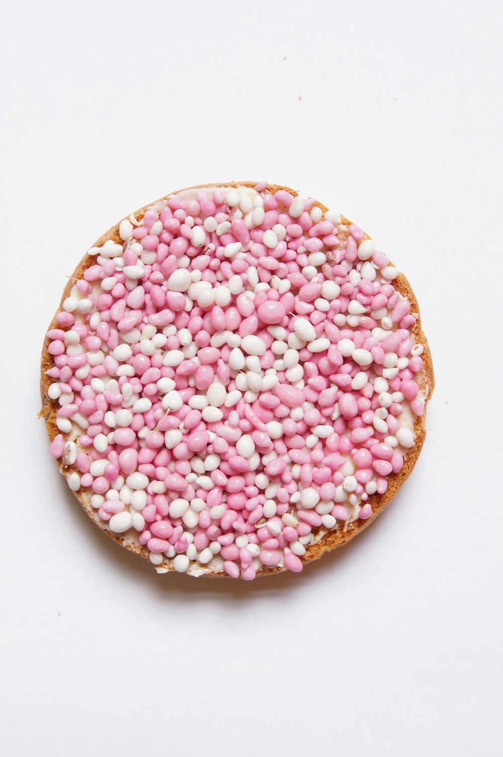 a cake with pink and white sprinkles on it