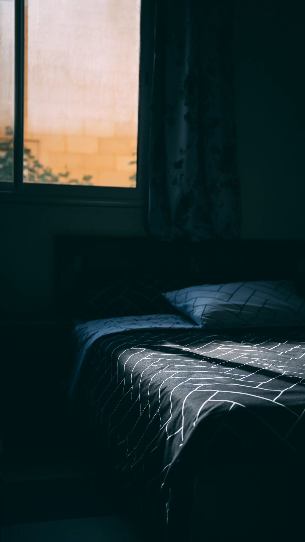 Bedroom with blackout curtains drawn across the window