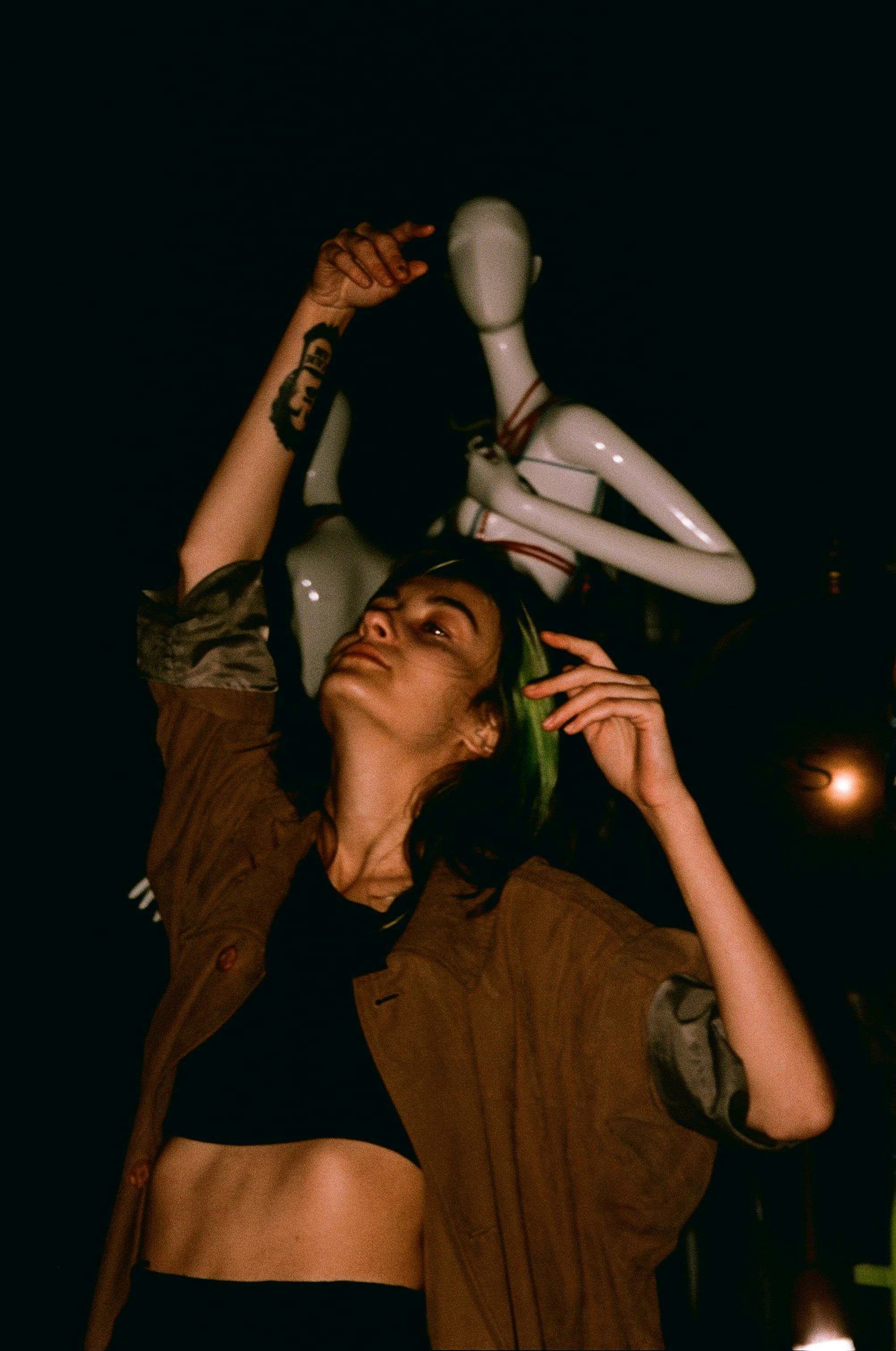 a woman holding up a mannequin in the air