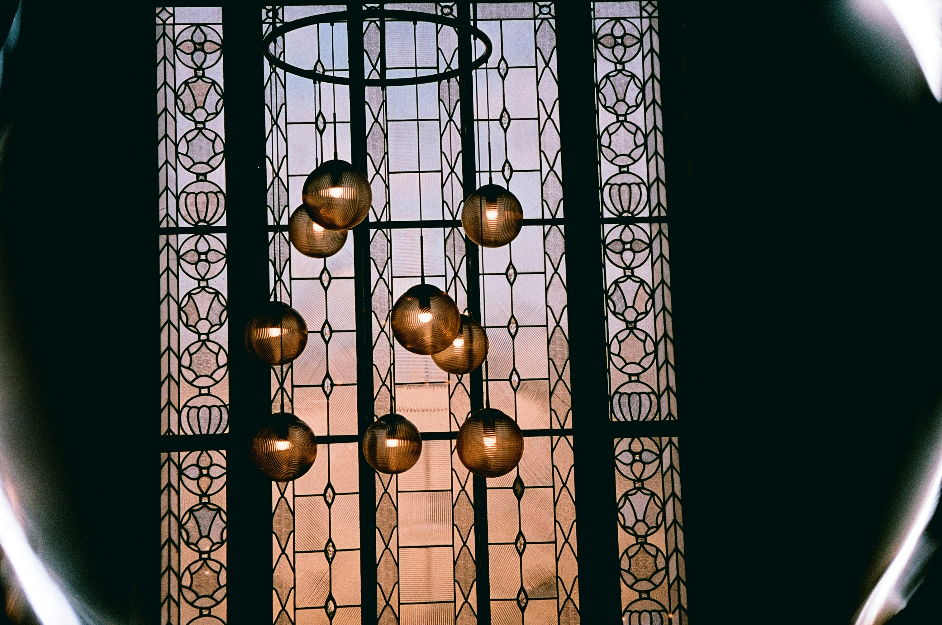 a close up of a stained glass window with a chandelier