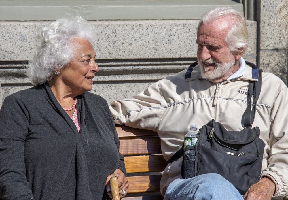 a man and a woman sitting on a bench