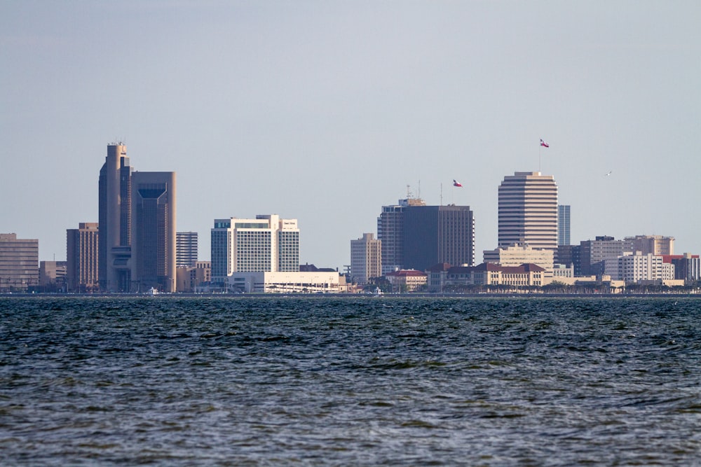 a large body of water with a city in the background