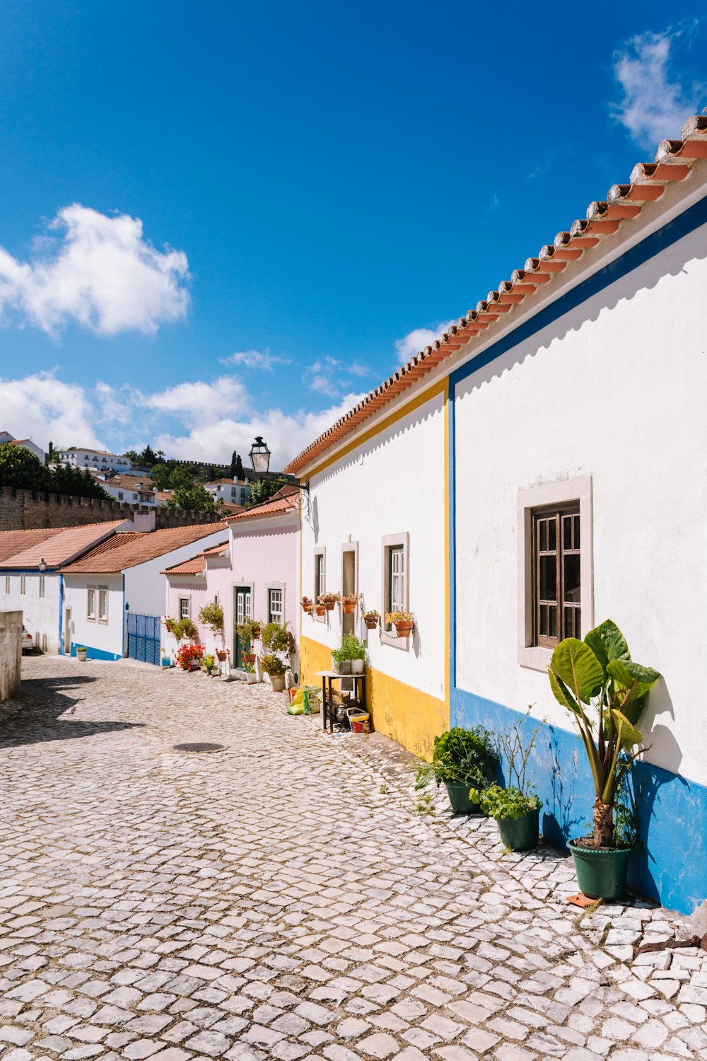 a cobblestone street lined with colorful houses