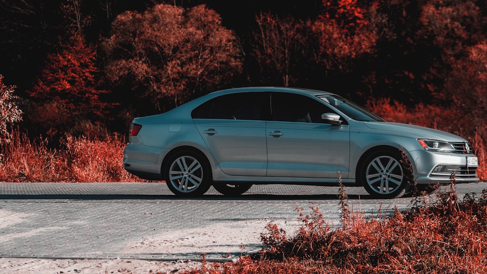 a silver car parked on the side of a road