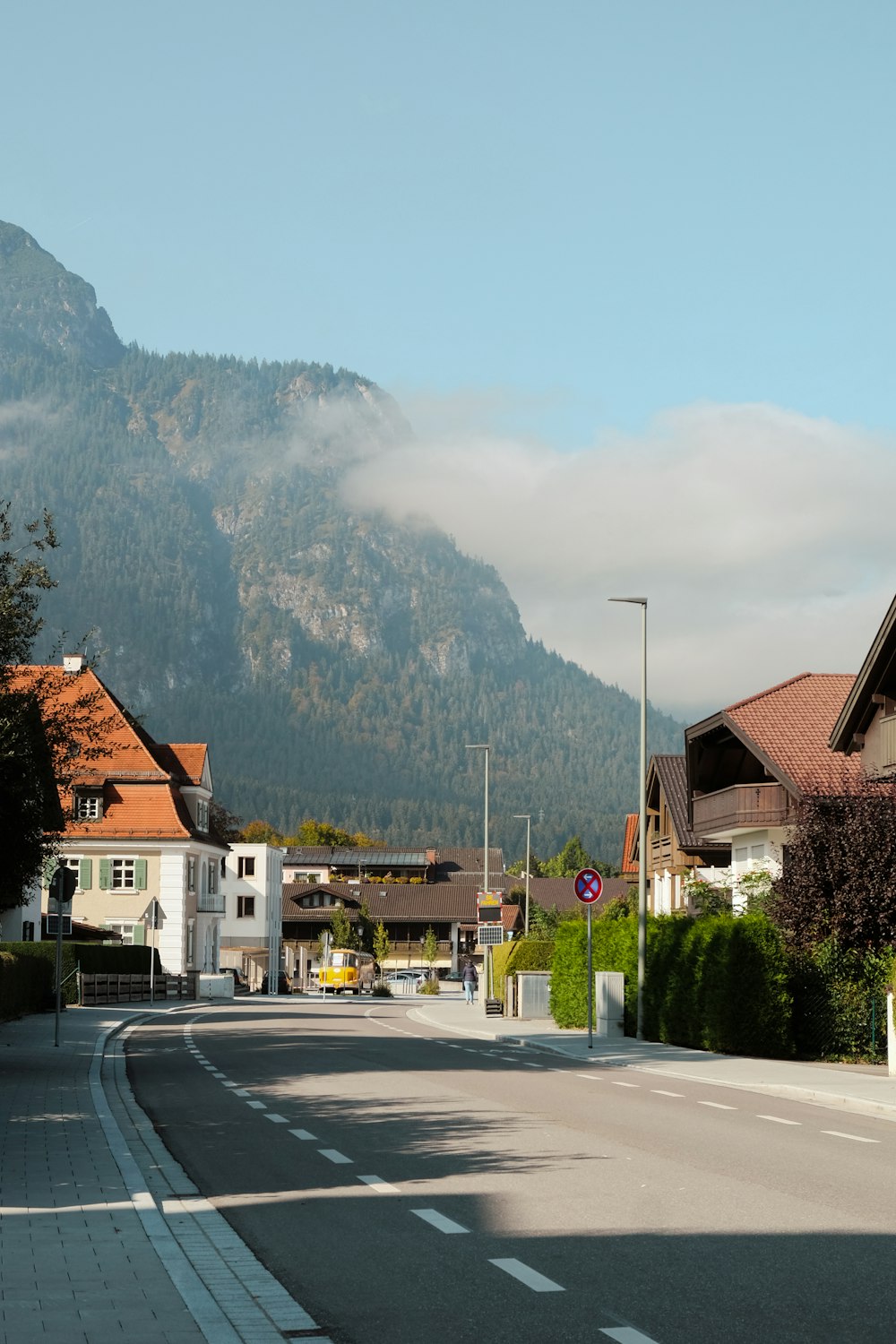 a street with houses and a mountain in the background