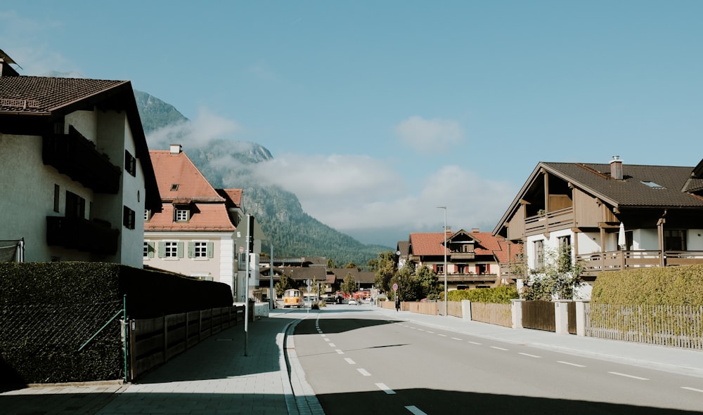 a street with houses and mountains in the background
