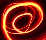 Bright, colorful lines weaving together in an elegant, continuous loop animation.