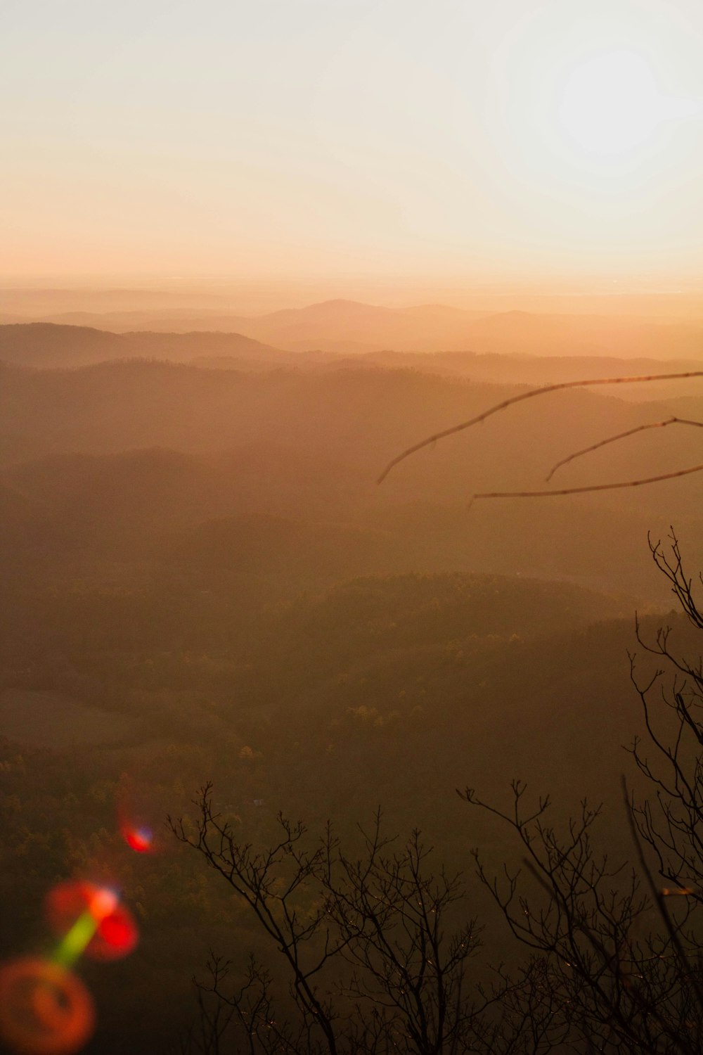 the sun is setting over the mountains in the distance