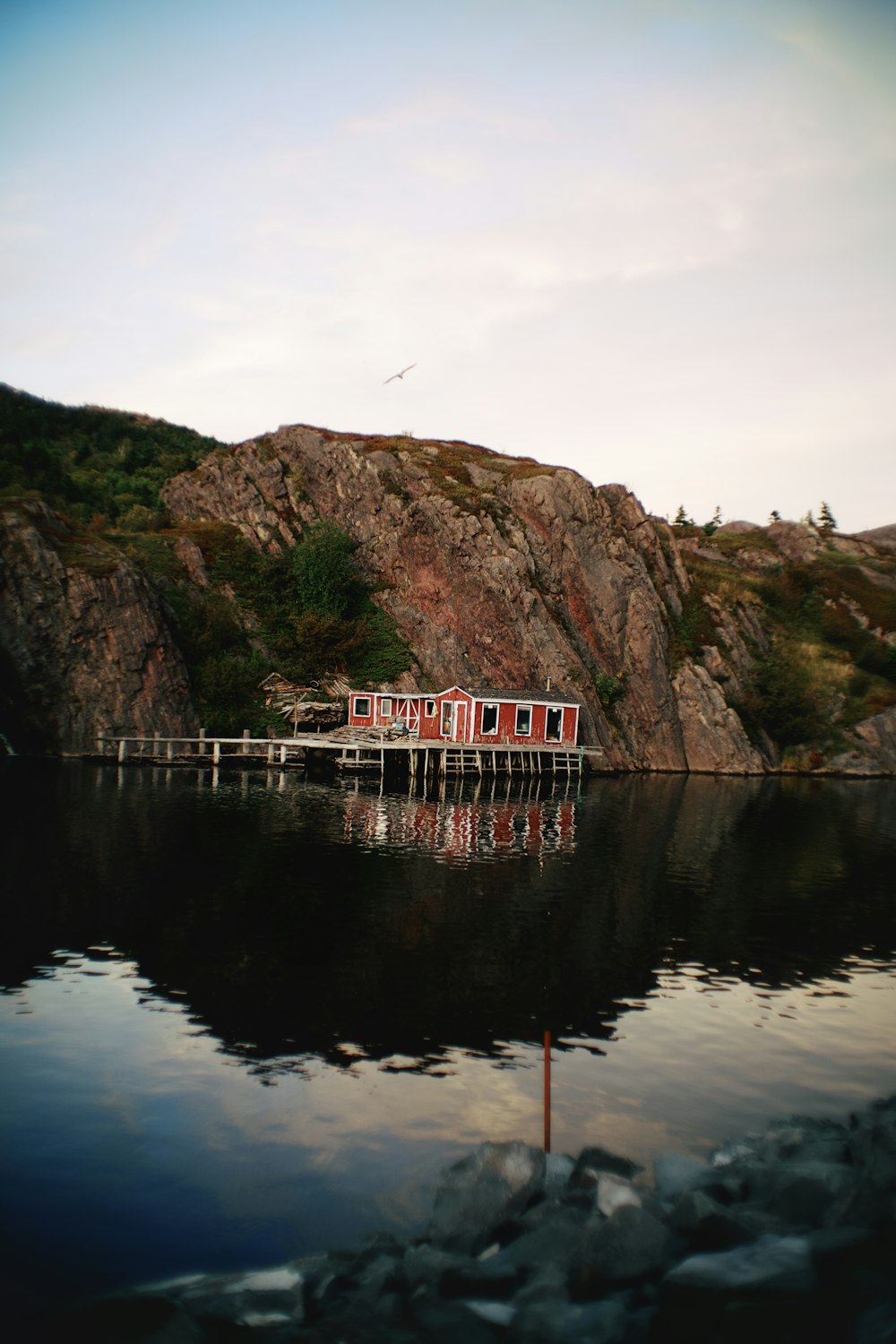 a boat is docked at the end of a mountain lake