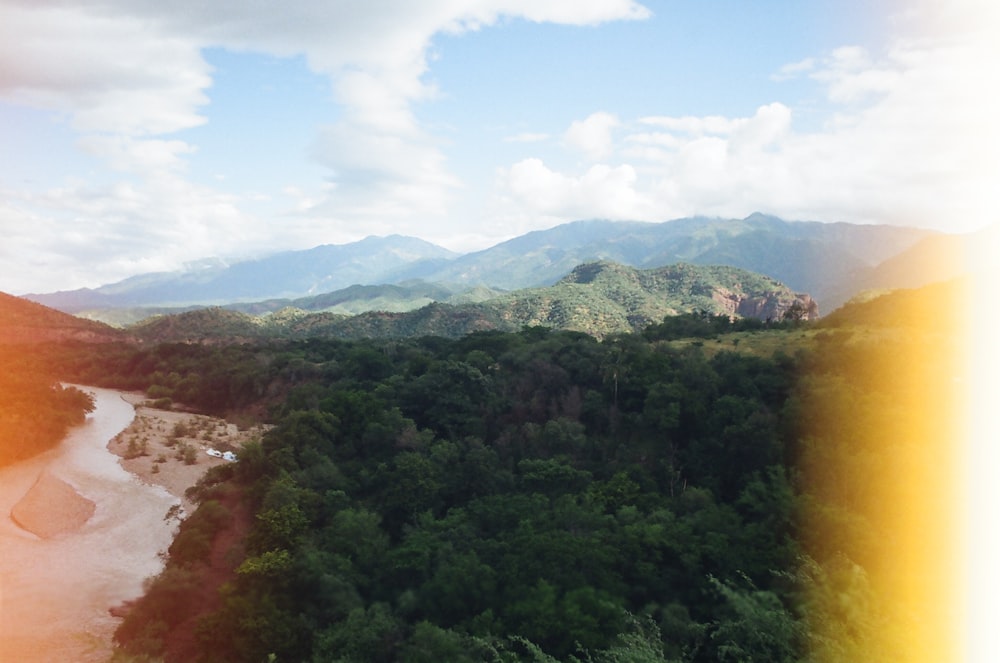 a scenic view of a mountain range with a river running through it