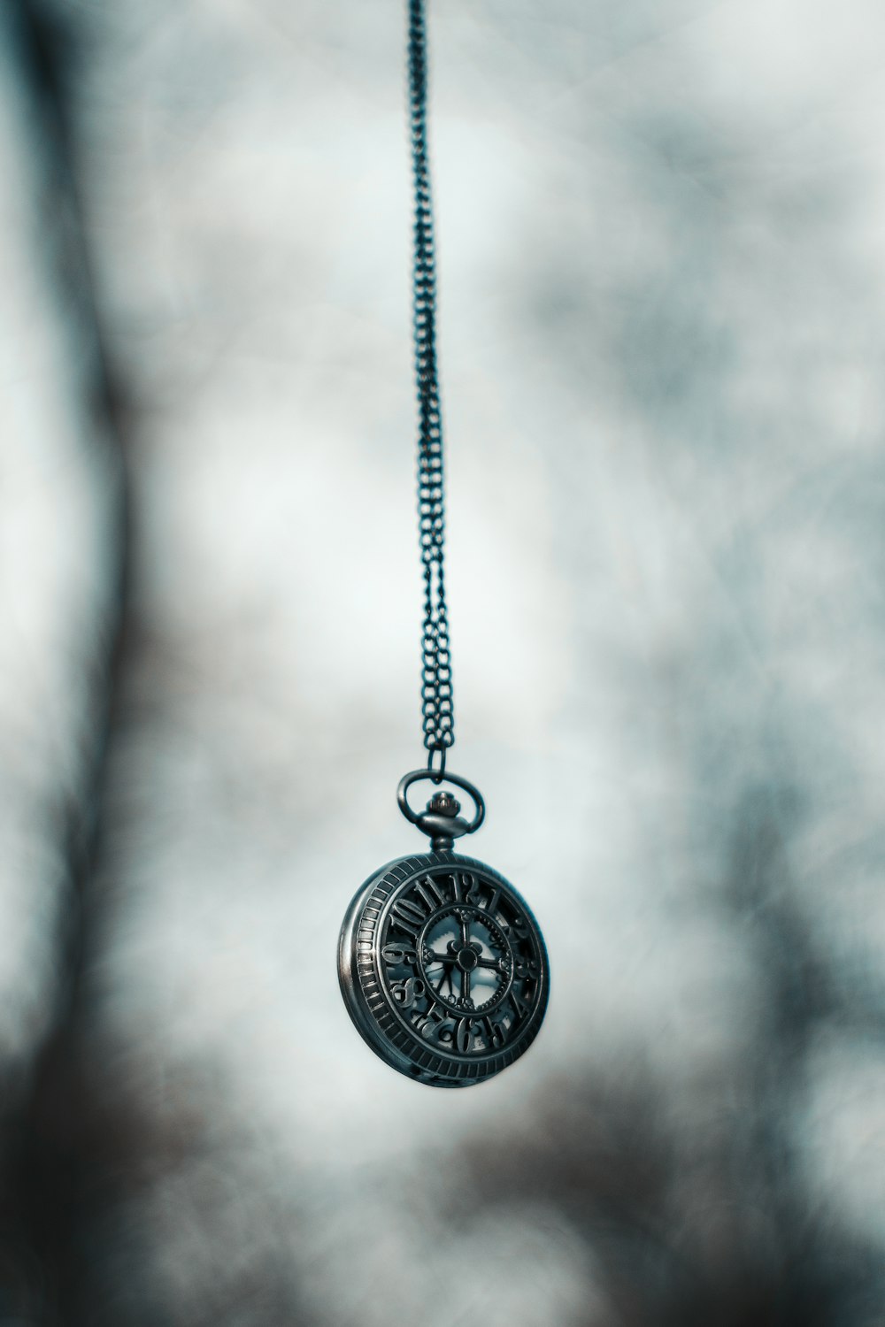 a close up of a clock on a chain