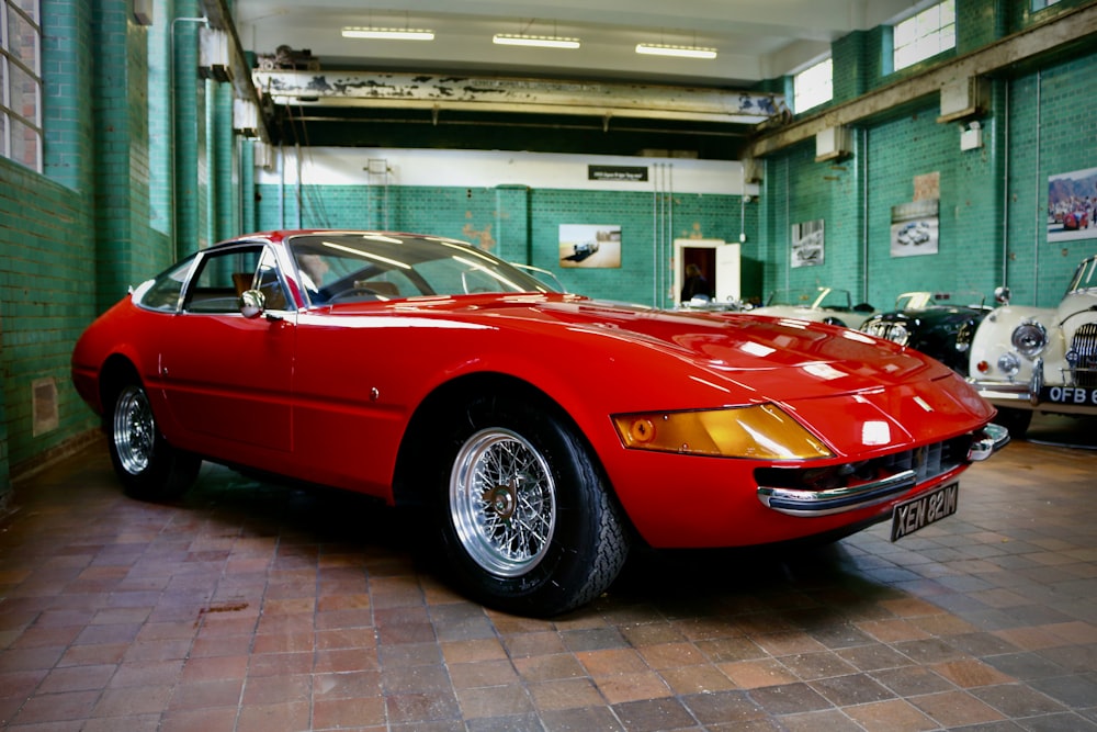 a red sports car parked in a garage