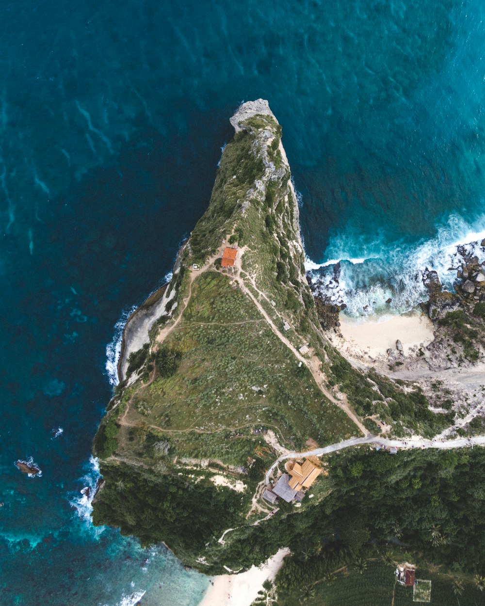 an aerial view of a small island in the middle of the ocean