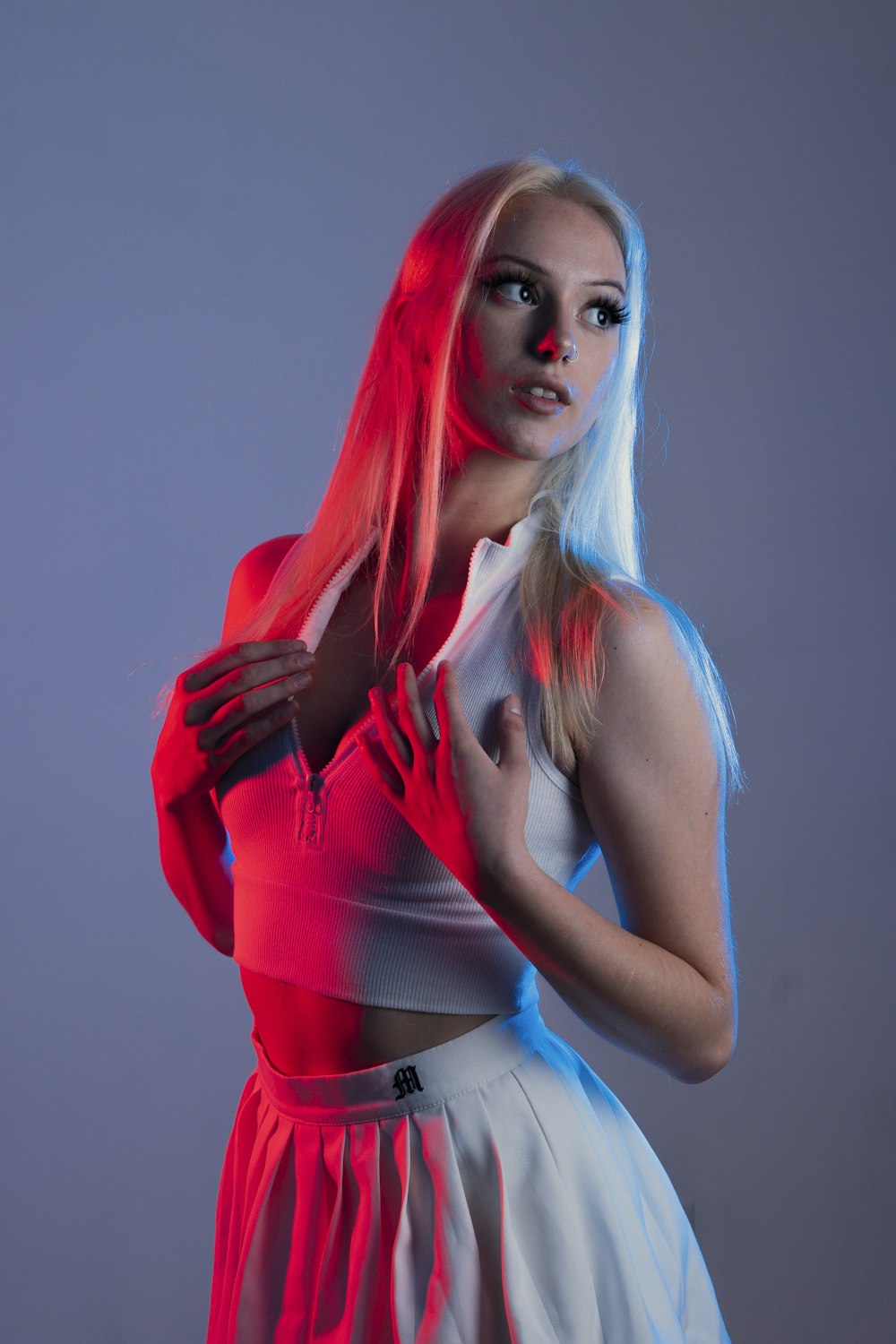 a woman with white hair wearing a red and white dress