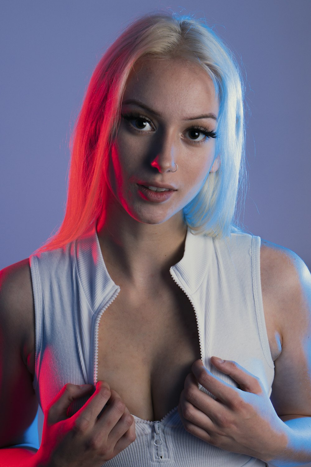 a woman with blue and pink hair wearing a white shirt