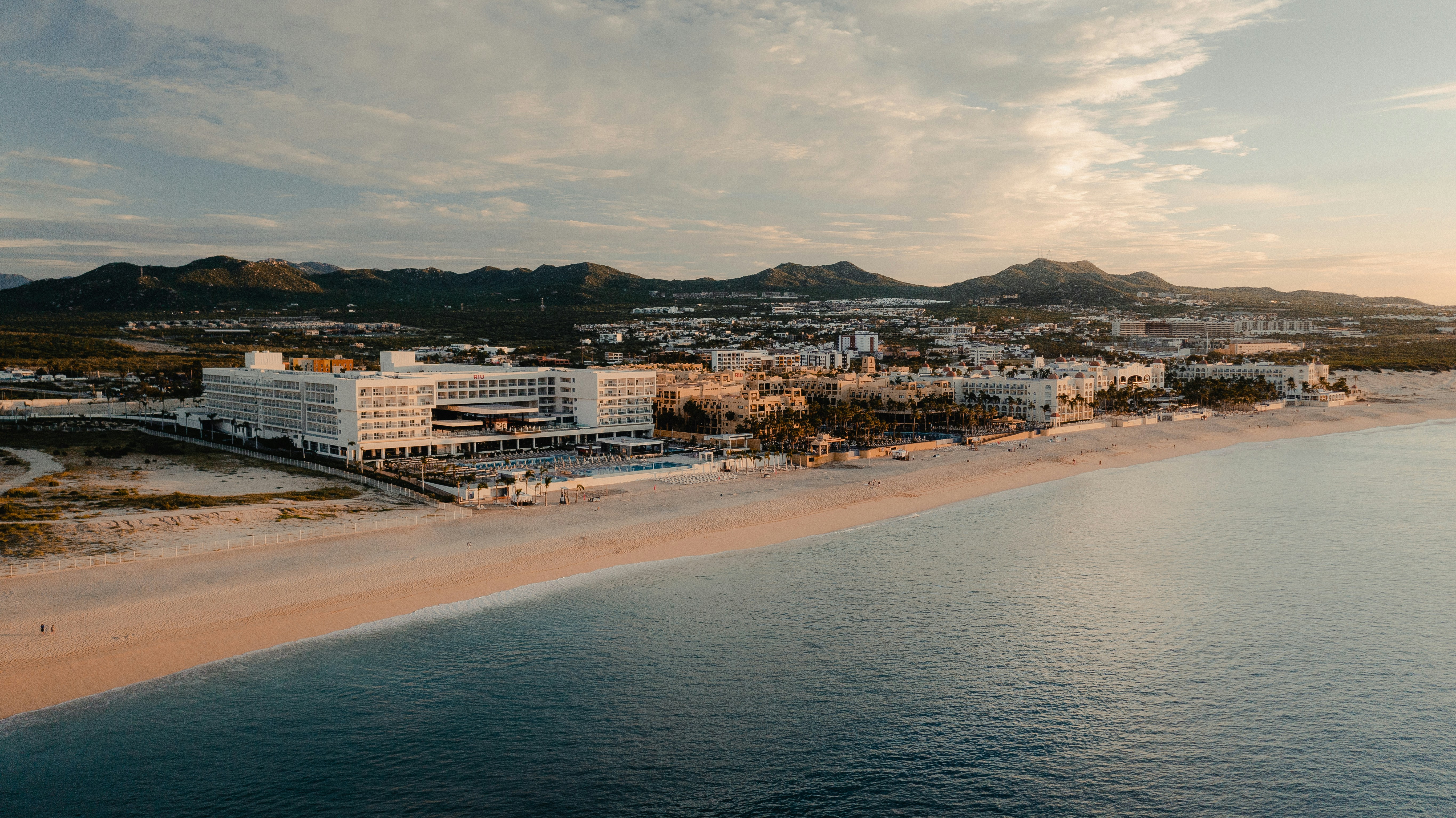 an aerial view of a resort on the beach, 