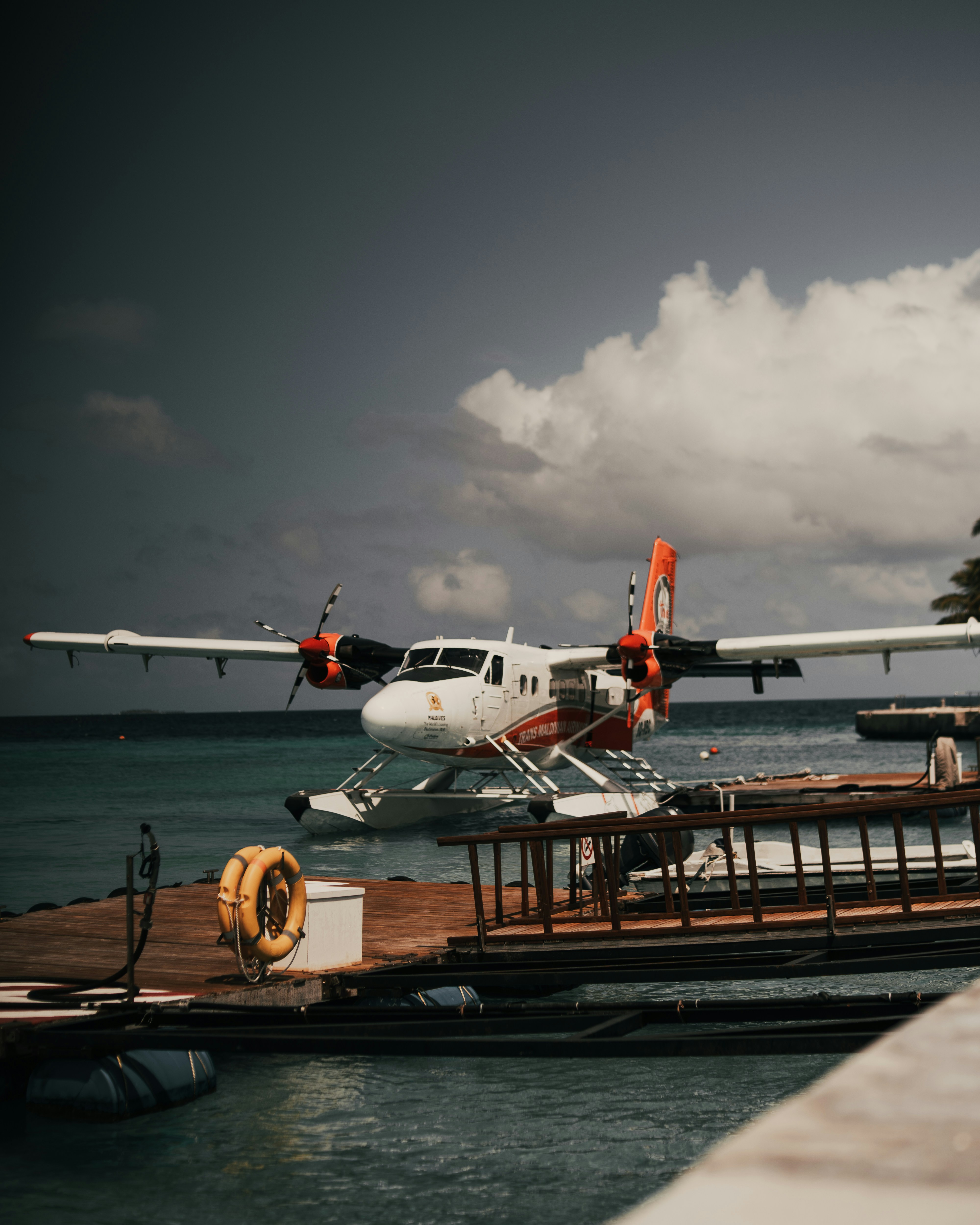 a sea plane sitting on top of a wooden dock