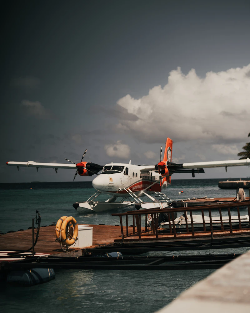 A seaplane sitting on a wooden jetty dock