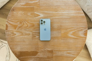 Close-up of a sleek smartphone on a wooden table