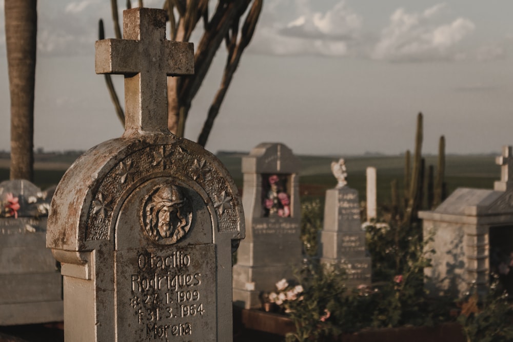 a cemetery with headstones and a cross