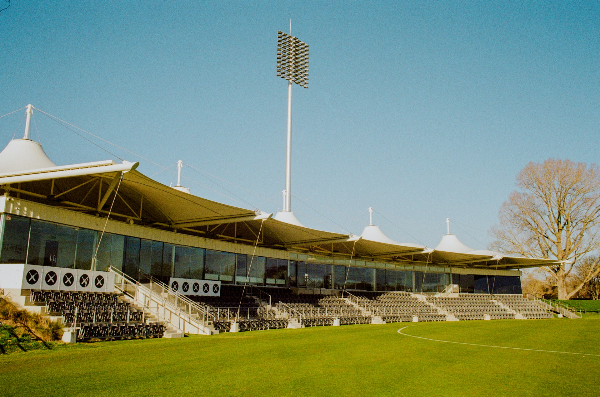 a soccer field with a large building and a soccer field