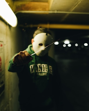 a person wearing a mask and holding a knife