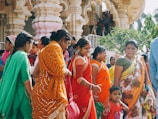 a group of women in colorful saris standing next to each other