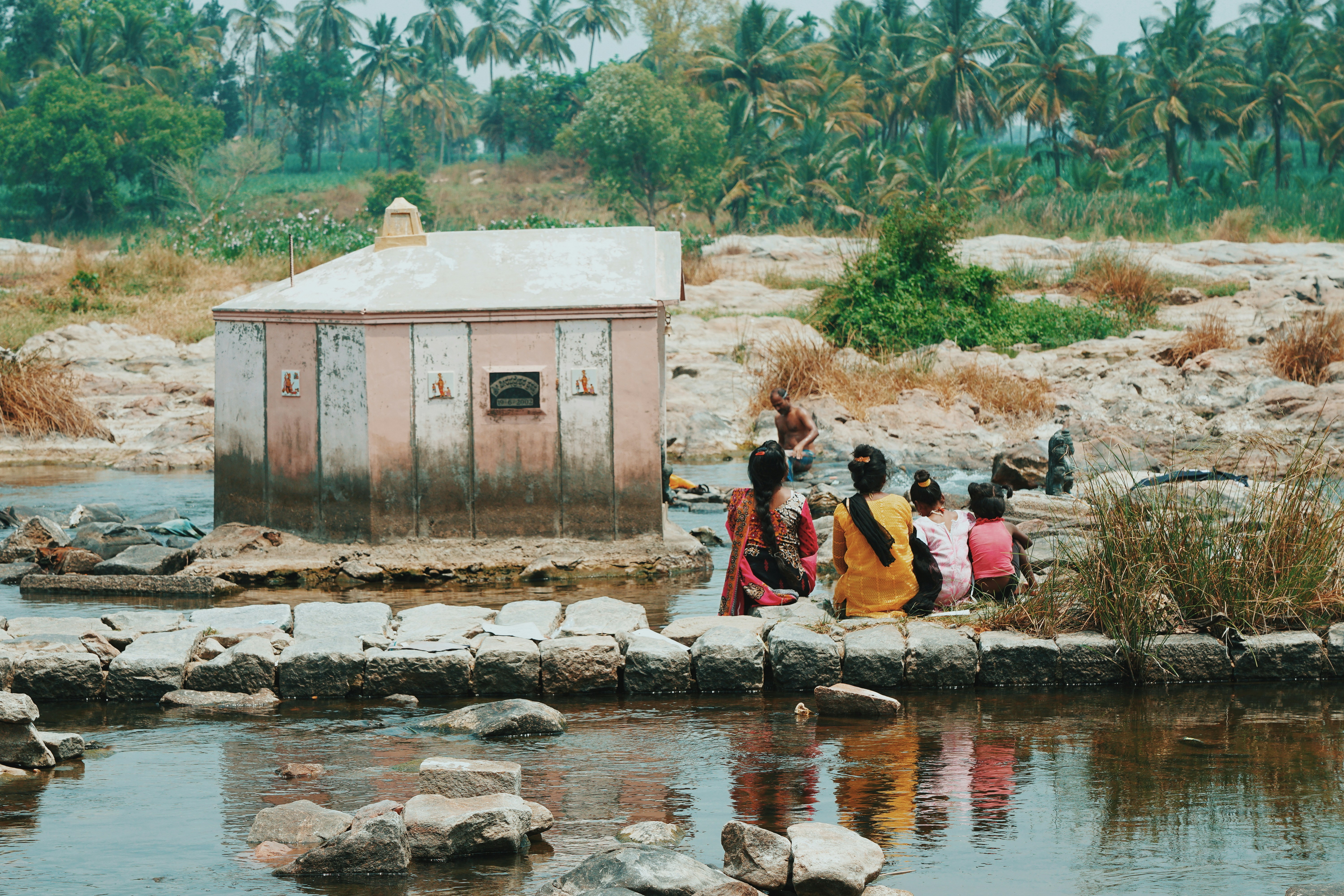 Group of people by water in India