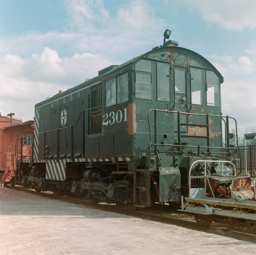 an old train is parked on the tracks