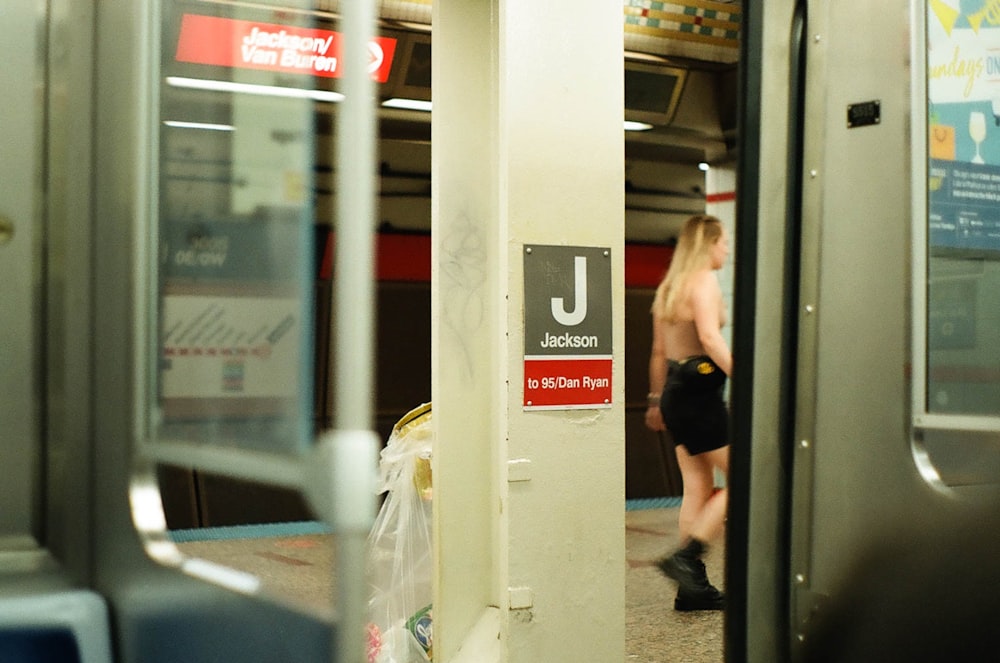 a person walking on a subway train next to a door