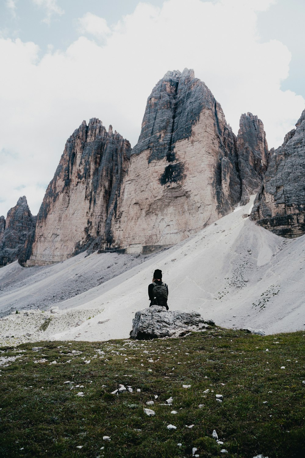 a person sitting on top of a snow covered hill