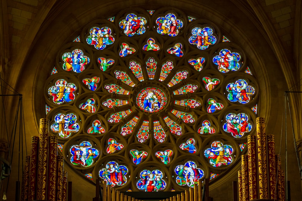 a large stained glass window inside of a church