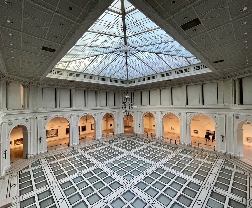 a large room with a glass ceiling and a chandelier