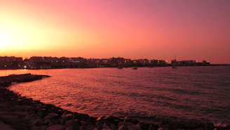 A scenic view of the northeastern coastline with fishermen at work during sunset.