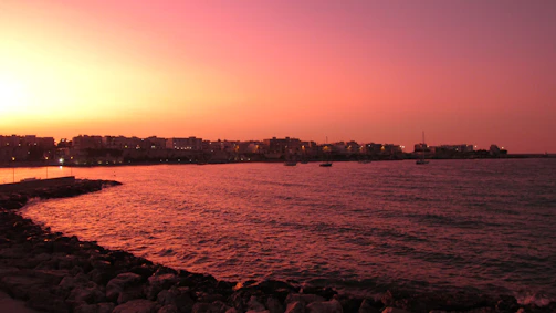 A scenic view of the northeastern coastline with fishermen at work during sunset.