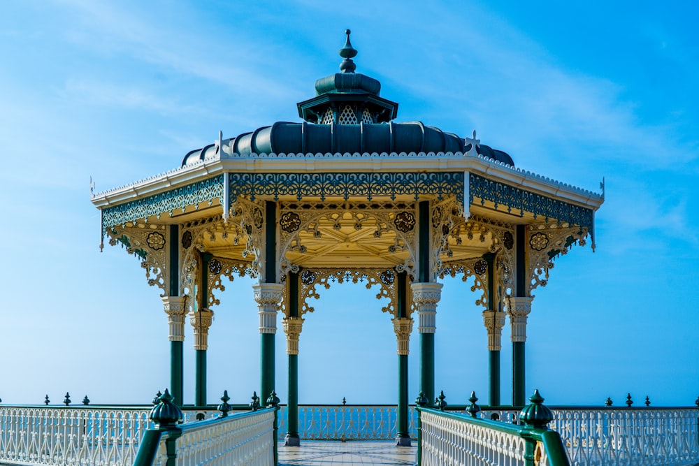 a gazebo sitting on top of a wooden bridge