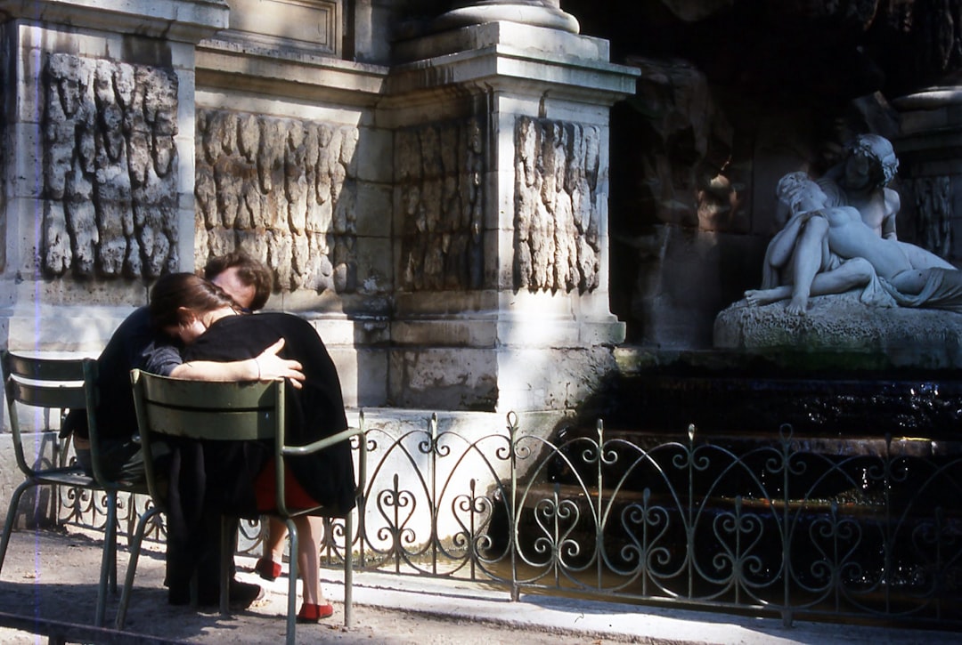 a couple of people that are sitting on a bench, Sadness on both.