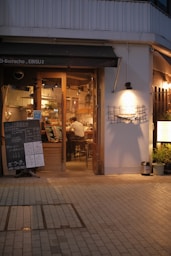 a restaurant with a sign in front of it