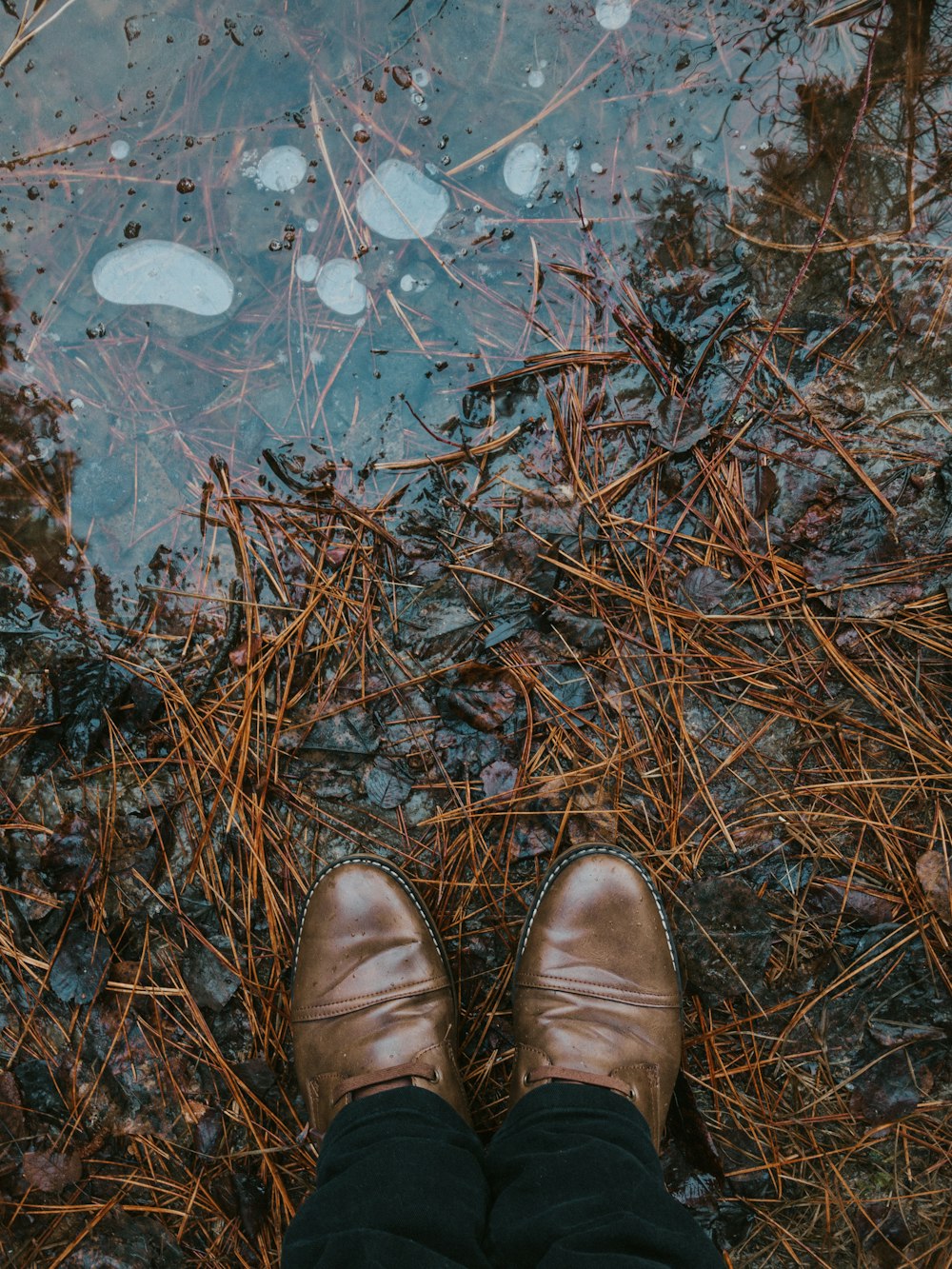 a person standing in front of a puddle of water