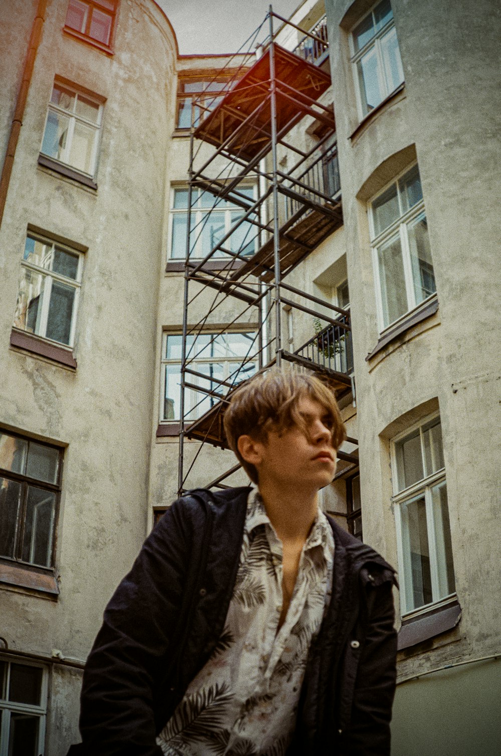 a woman standing in front of a tall building