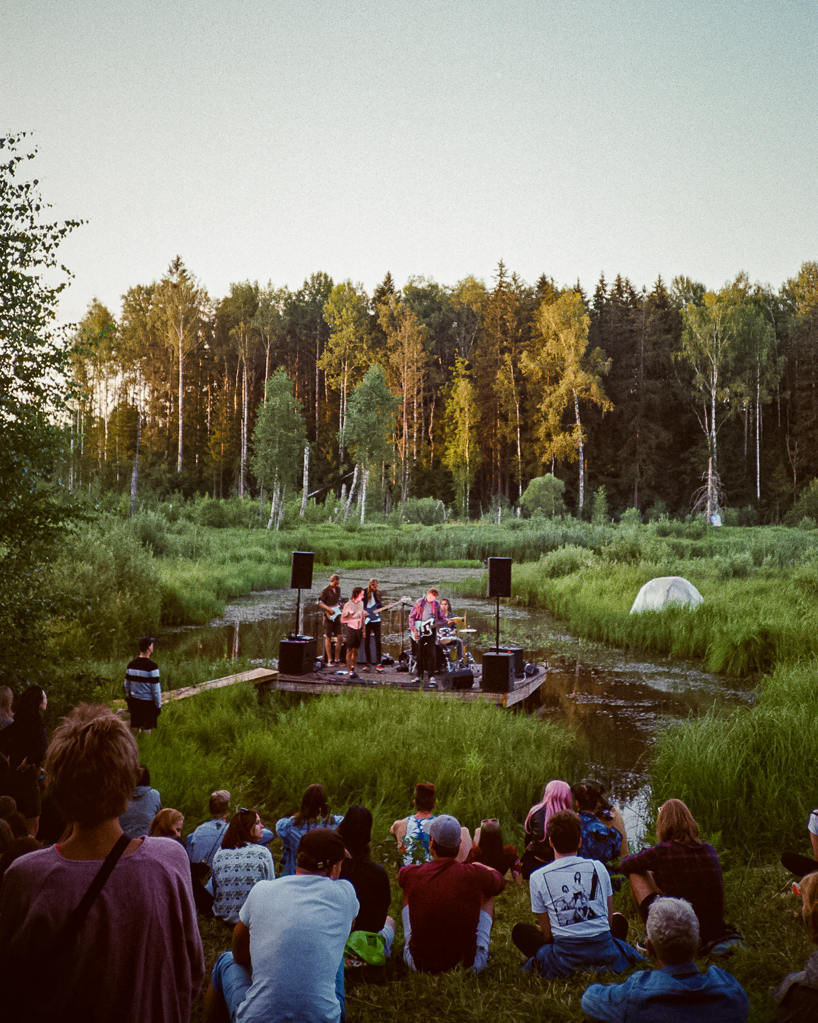 Outdoor music festival under evening lights