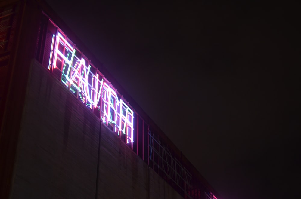 a neon sign on the side of a building