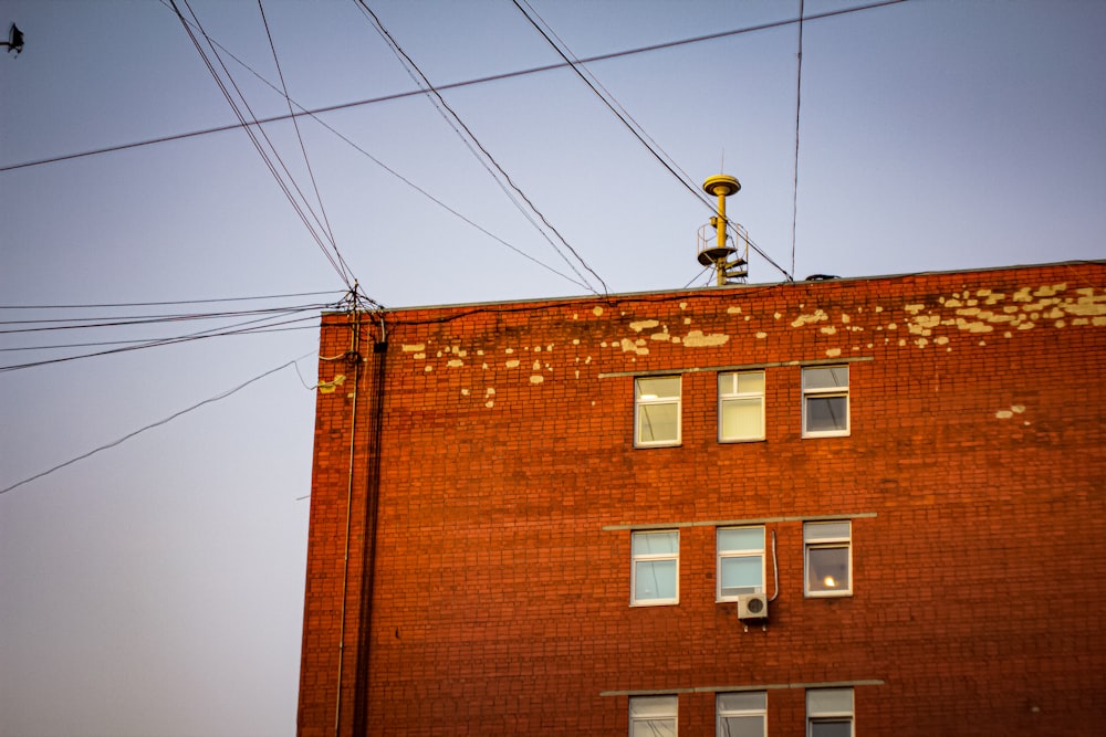 a red brick building with power lines above it