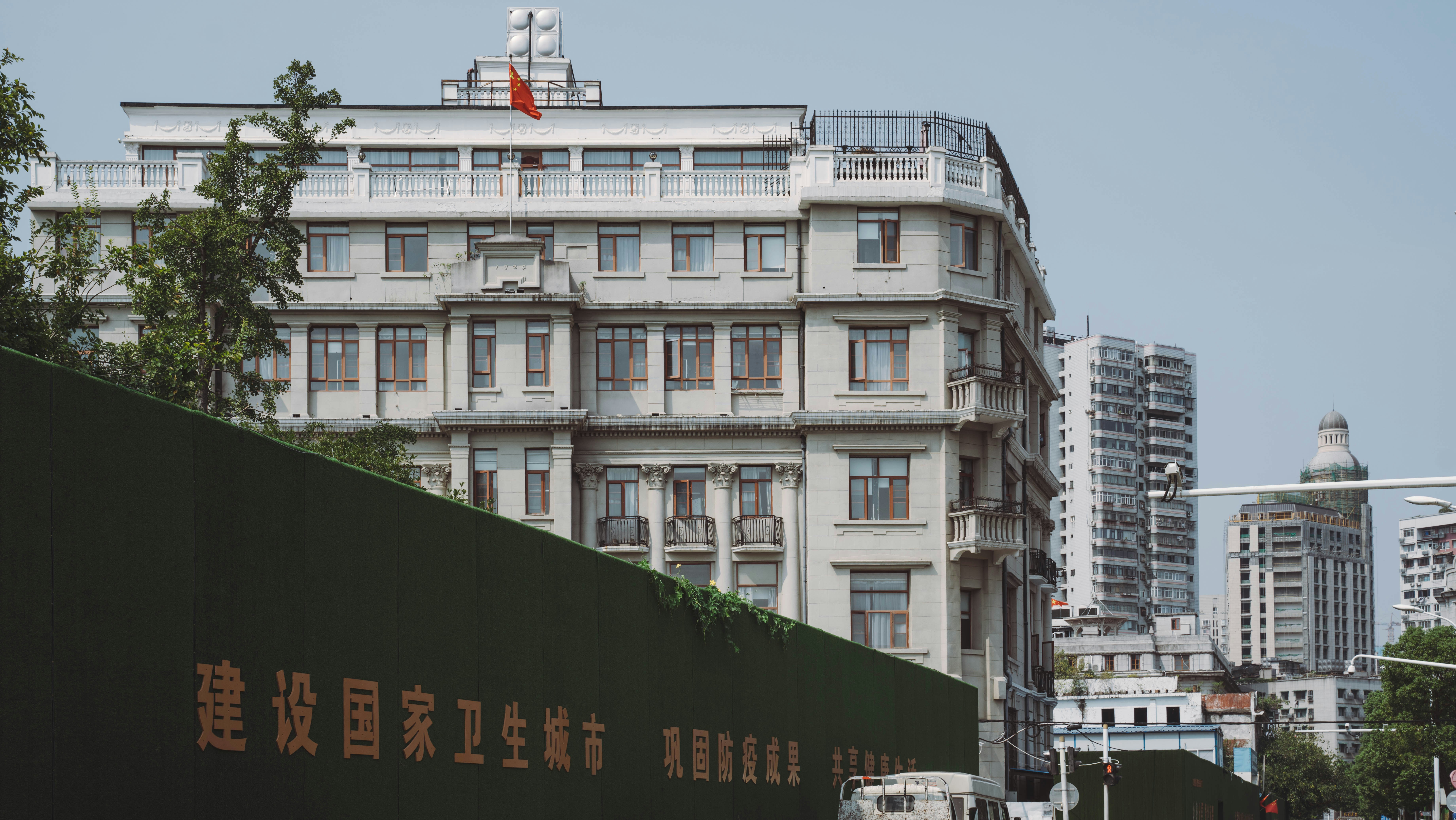 a city street with a large building in the background