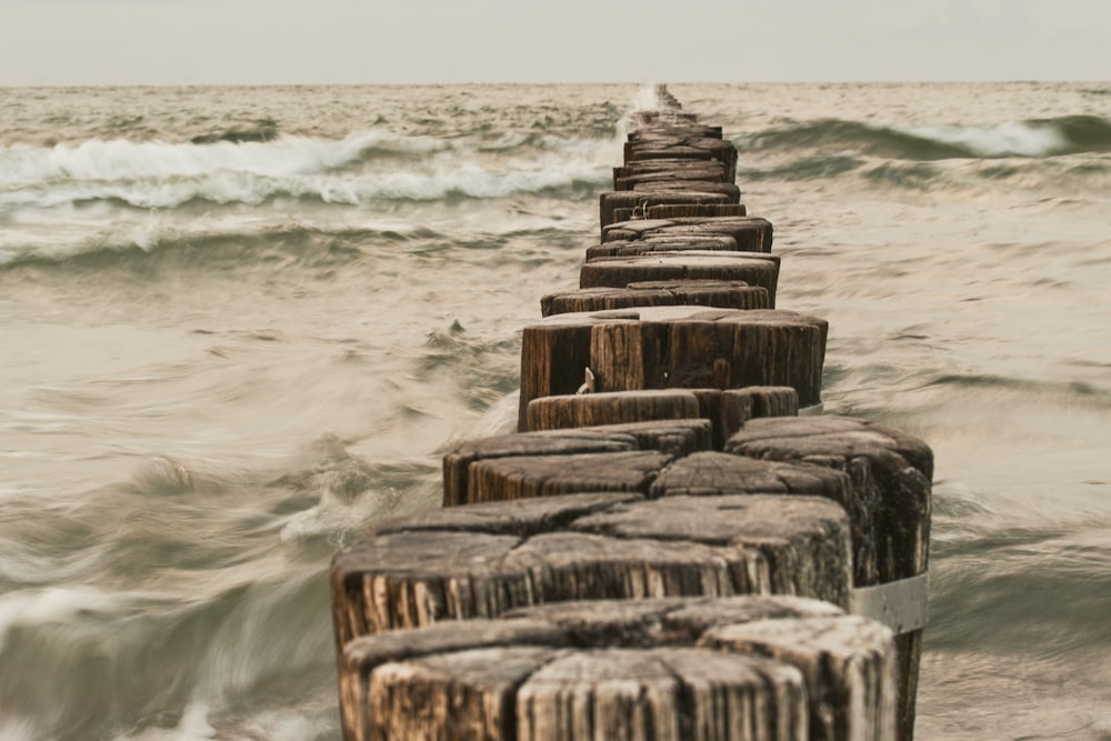 a long wooden dock in the middle of the ocean