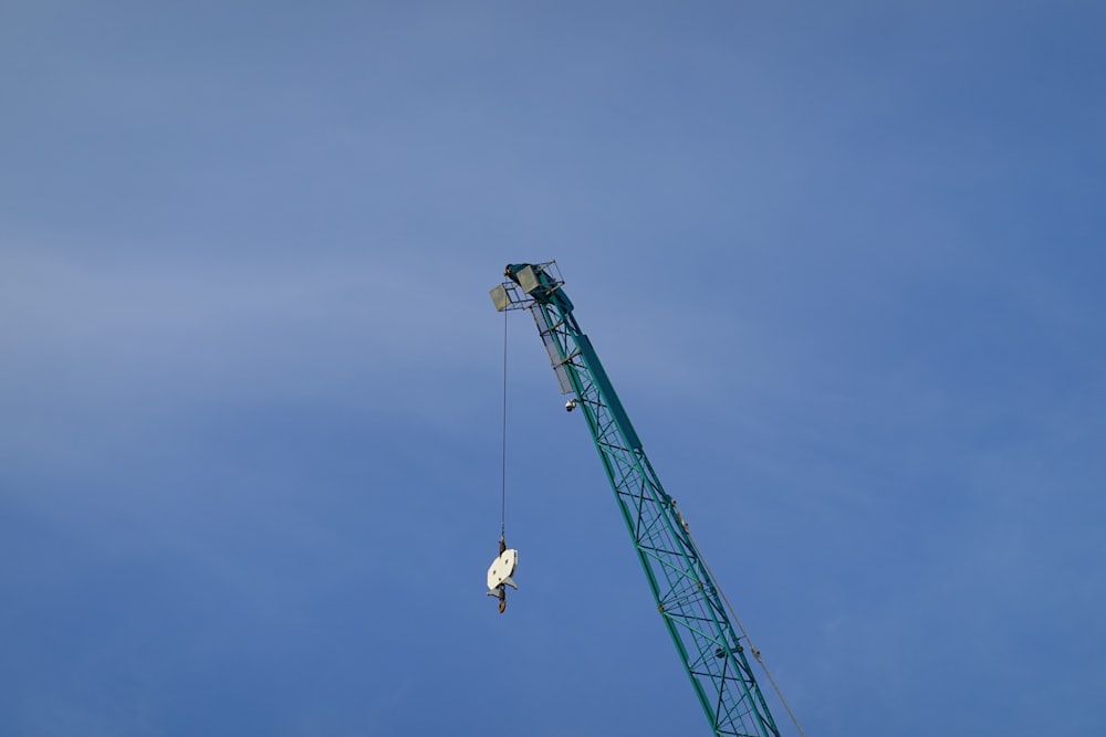 a crane is lifting a piece of paper into the air