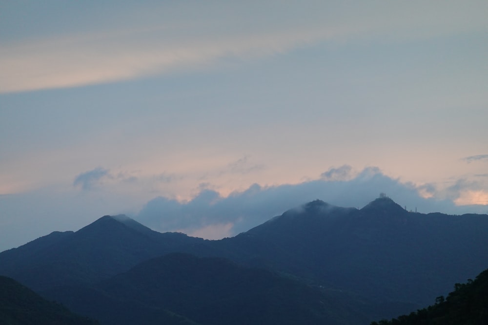 a view of a mountain range with clouds in the sky