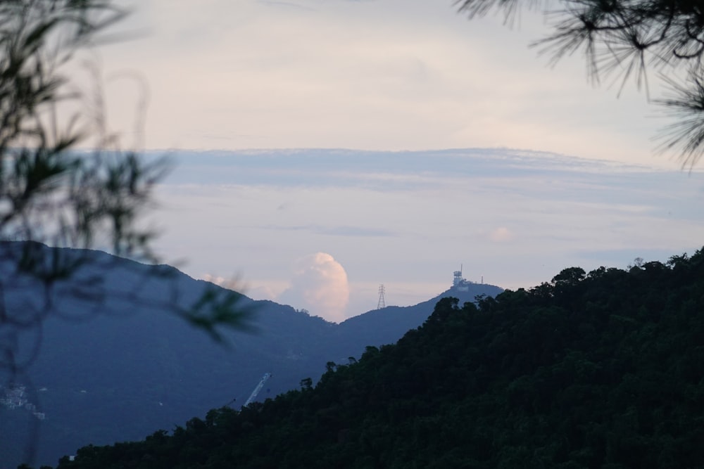 a view of a mountain with a tower in the distance