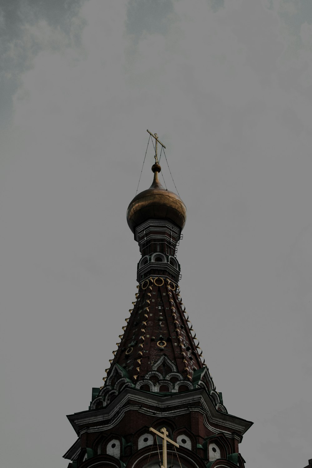 a clock tower with a weather vane on top of it